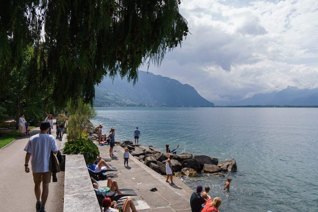 Cozy lakeside cafe terrace in Montreux with mountains in the background