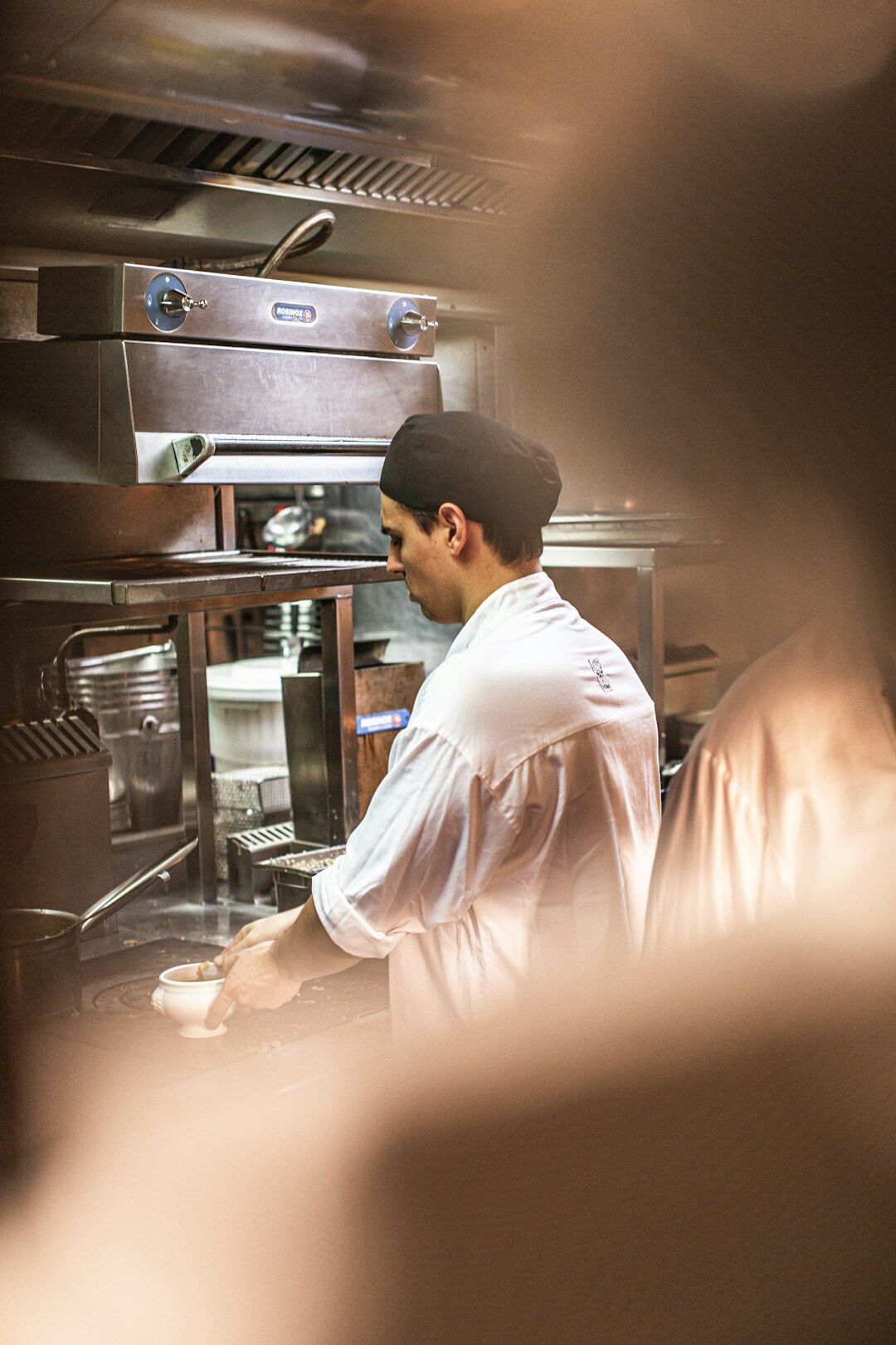 parisian chef preparing dish